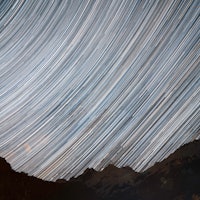 Star Trails across a night sky. Composite of hundreds of frames plotting the movements of shooting s...