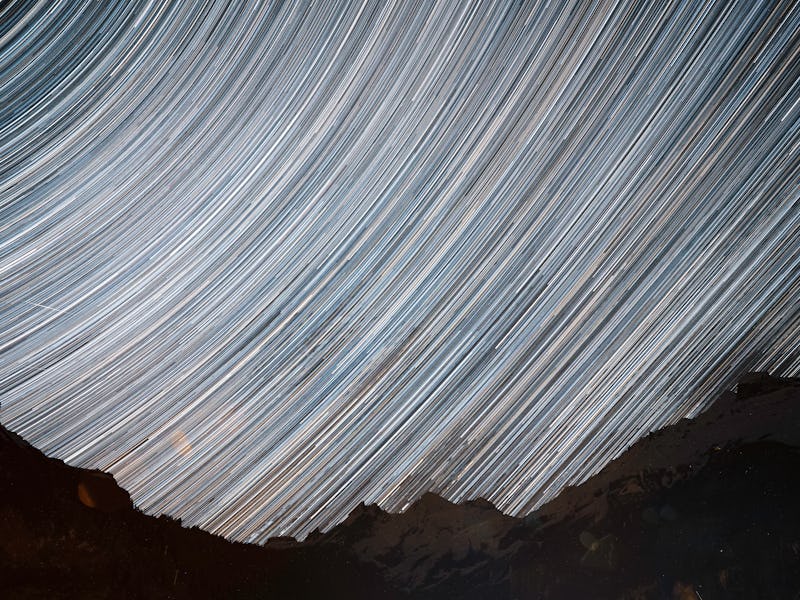 Star Trails across a night sky. Composite of hundreds of frames plotting the movements of shooting s...