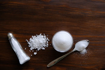 Natural seasoning, organic, sea, small and large, white salt in a spoon, in a Cup, in a salt shaker,...