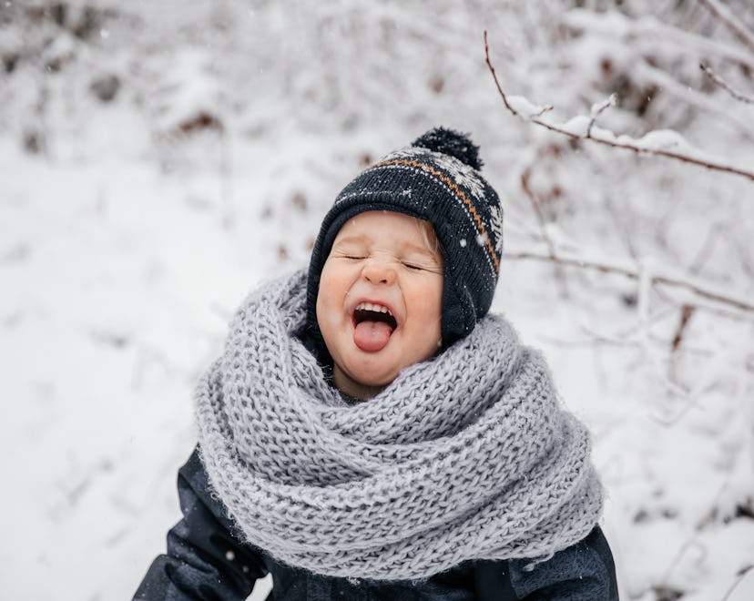 Winter portrait of little boy child in snow. Cute kid - winter