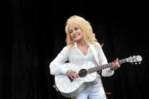 Dolly Parton in a white sparkly outfit.