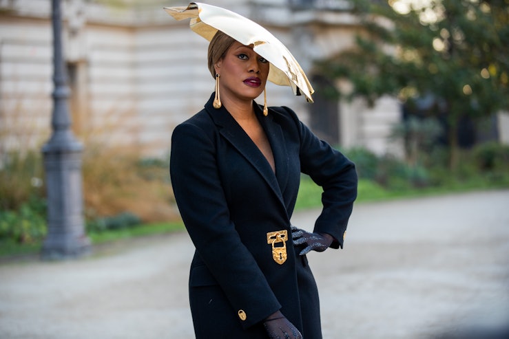 PARIS, FRANCE - JANUARY 24: Laverne Cox is seen wearing golden hat, black wool coat, gloves outside ...