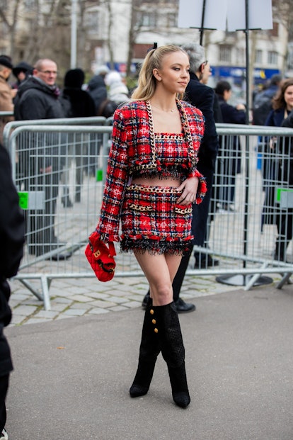 Sydney Sweeney wearing a red checkered Balmain outfit during Paris Fashion Week. 