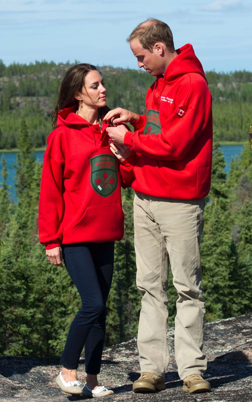 Prince William and Kate Middleton in matching red sweatshirts. 