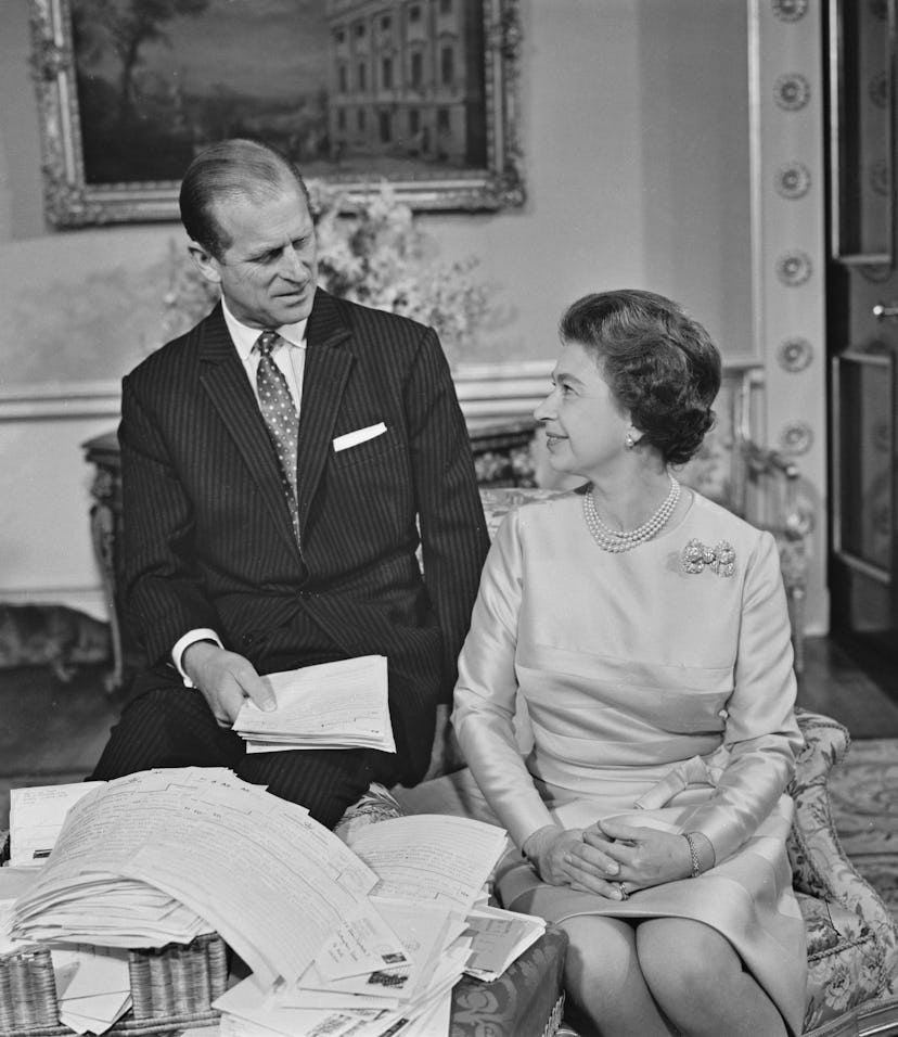 Queen Elizabeth II and Prince Philip, the Duke of Edinburgh (1921 - 2021) sort through their mail on...