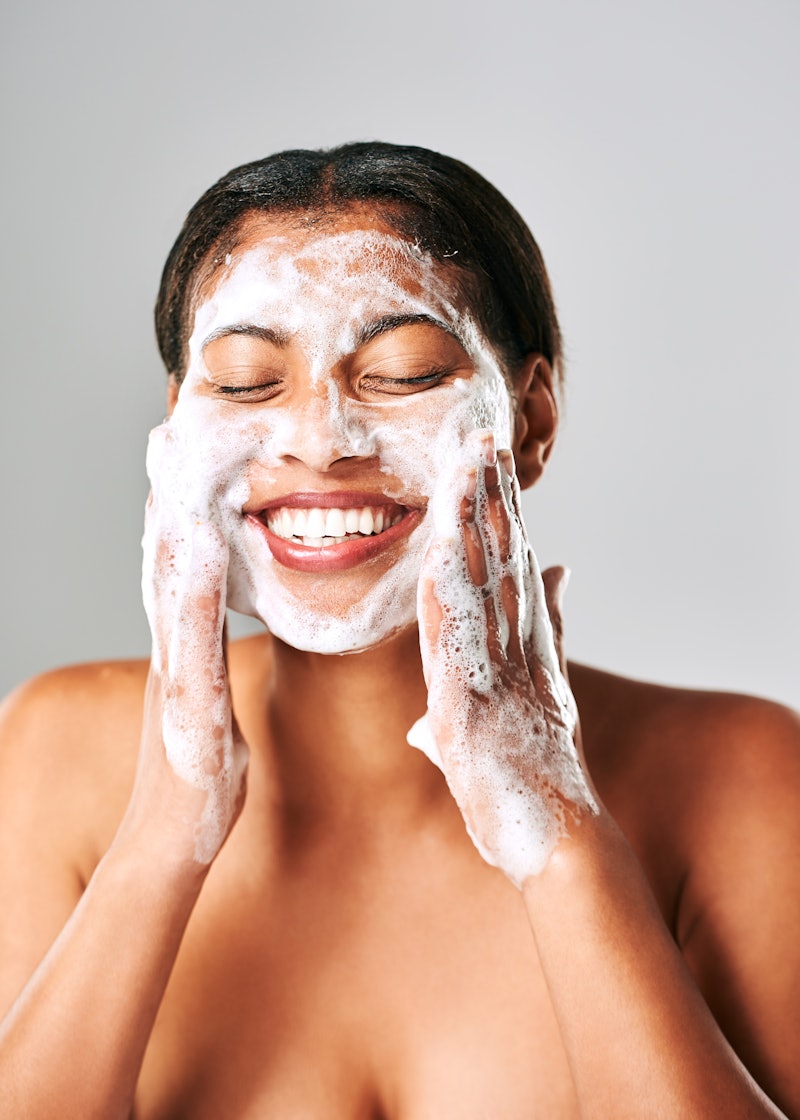 Woman, cleansing her face as part of her skin care routine for acne-prone skin