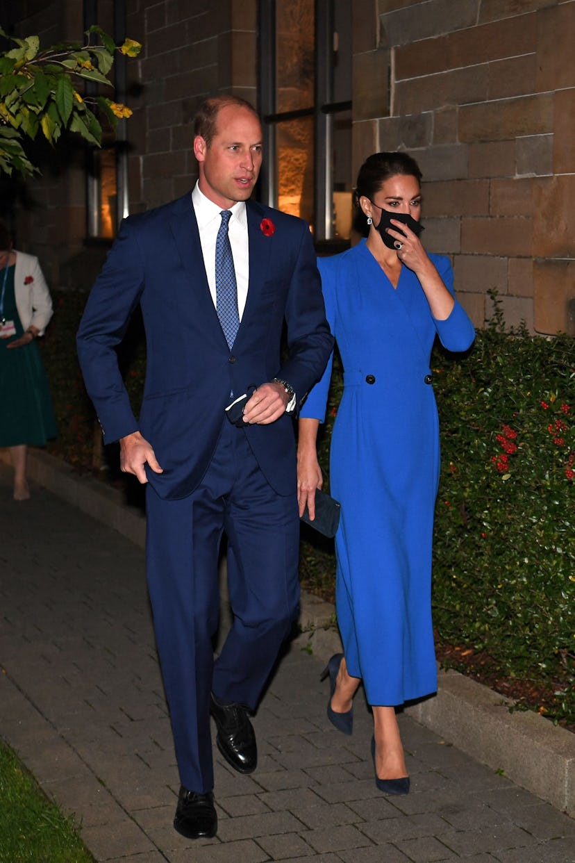 Prince William and Kate Middleton in matching blue outfits. 