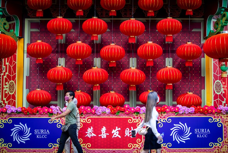 People walk past the Lunar New Year decorations in Malaysia, which is one of the countries that cele...