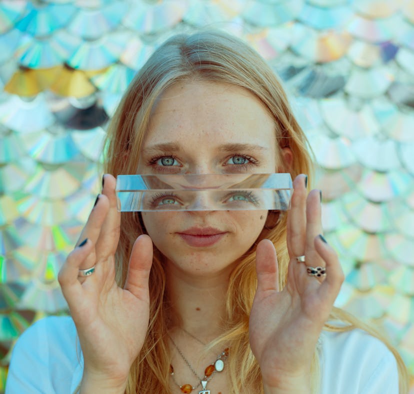 Young woman with blue eyes, embracing the spiritual meaning of the February 2022 new moon in Aquariu...