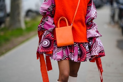 PARIS, FRANCE - JANUARY 25: A guest wears a neon orange felt / fluffy sleeveless pullover, a pink / ...