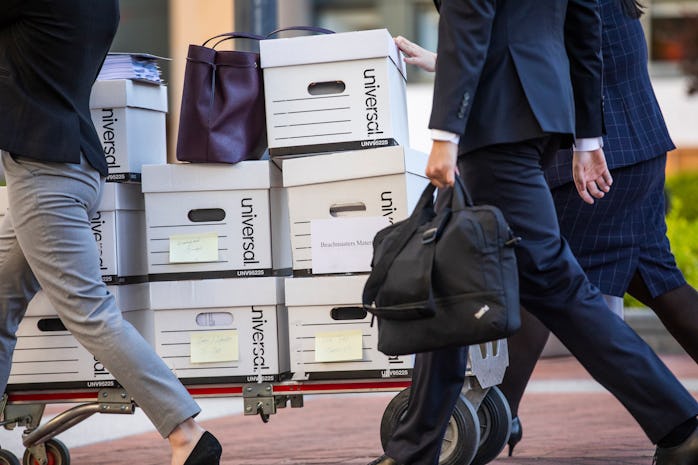 OAKLAND, CA - MAY 21: Legal staff representing Epic Games push a cart of documents for trial at the ...