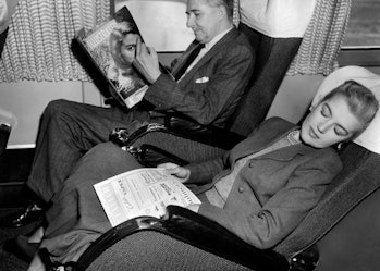 Couple on plane. British Overseas Airways Corporation. boac. 1958. (Photo by: Touring Club Italiano/...