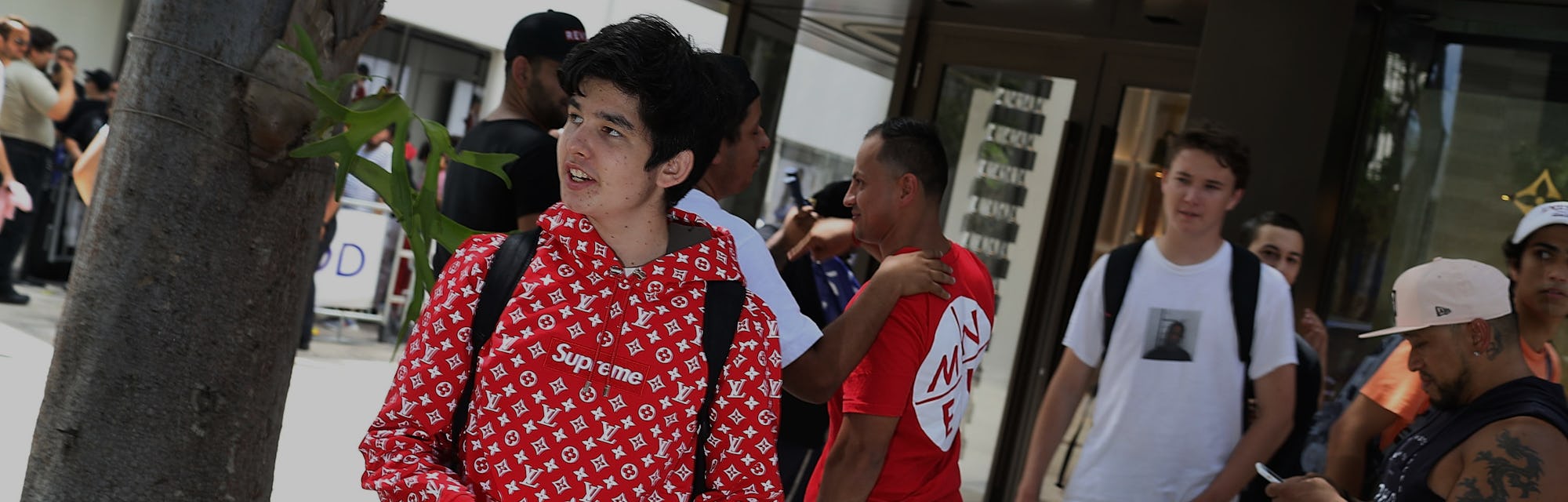 MIAMI, FL - JUNE 30:  Mateo Lorente (L) wears his new Supreme shirt as people flock to the Louis Vui...