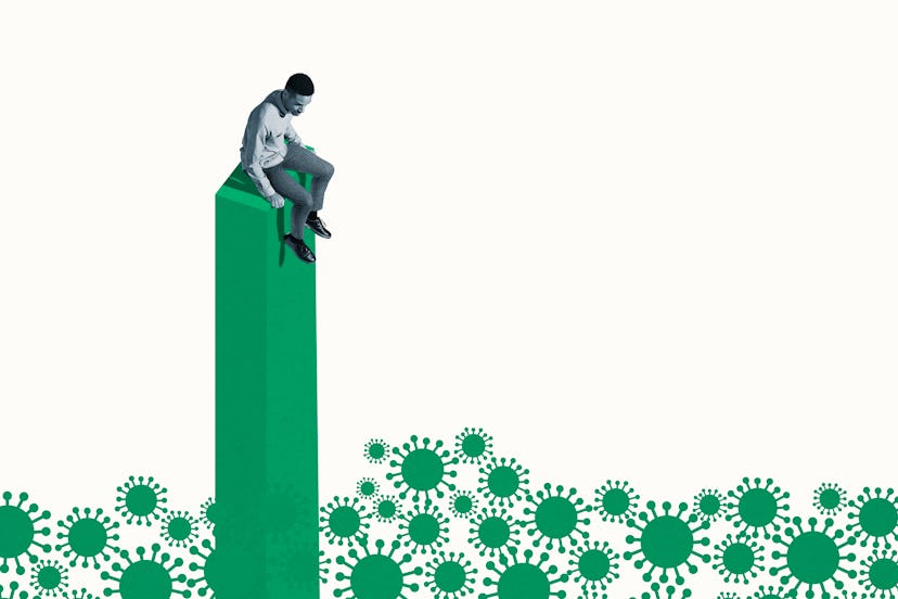 Scared young man sitting on top of green column while looking down at coronavirus against white back...