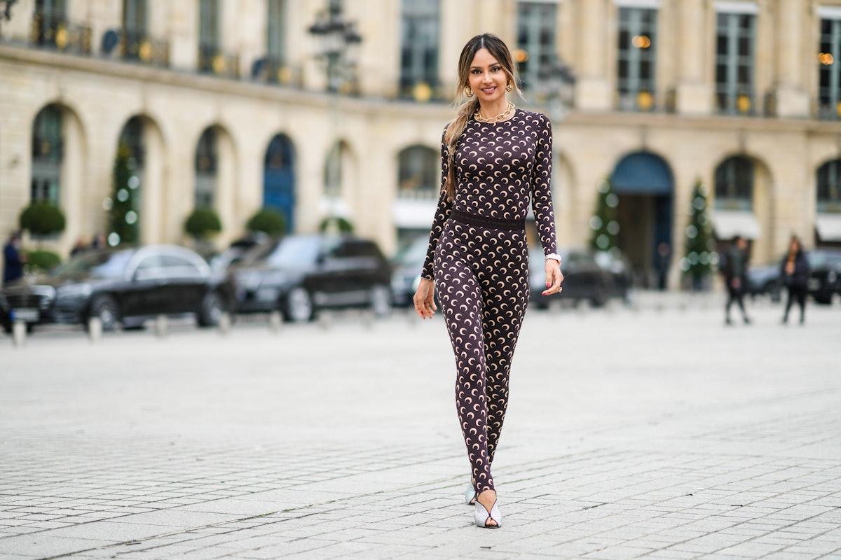 A street style photo of someone wearing a patterned catsuit in Paris, France. 