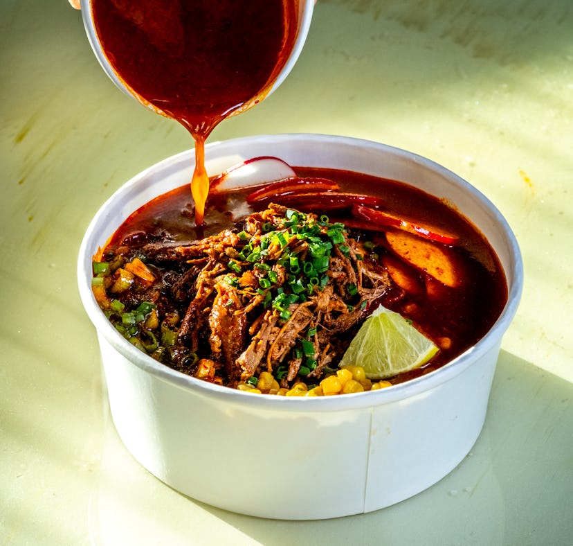 NORTH BETHESDA, MD - NOVEMBER 9: Consommé is poured into birria ramen at Little Minor Taco, which is...