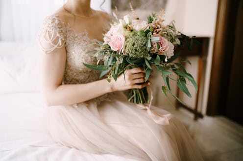bride on her wedding day holding a bouquet of flowers