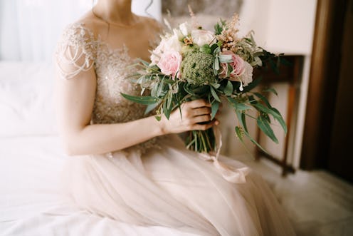 bride on her wedding day holding a bouquet of flowers