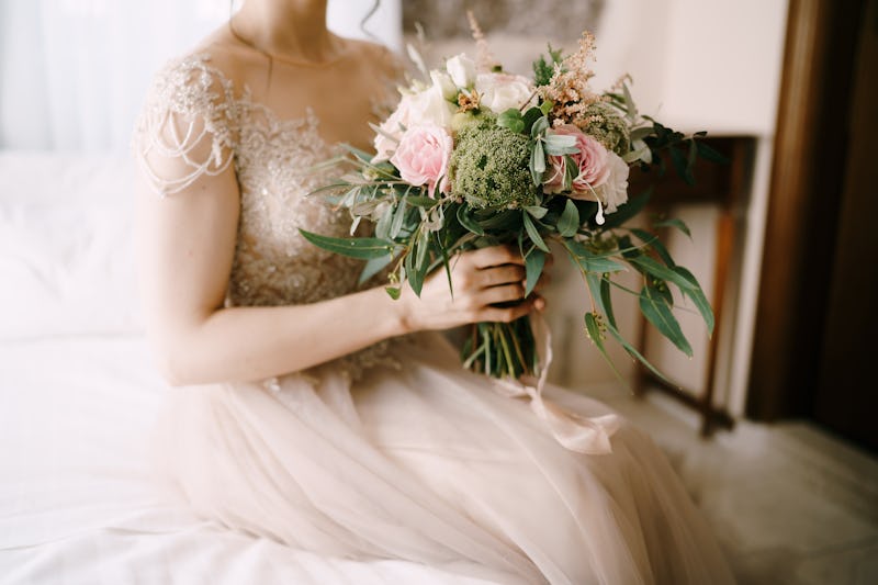bride on her wedding day holding a bouquet of flowers