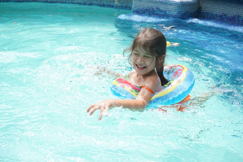 a kid playing in the pool