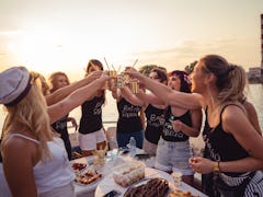 Cheerful bride and bridesmaids celebrating with a bachelorette party, for which they need a bridesma...