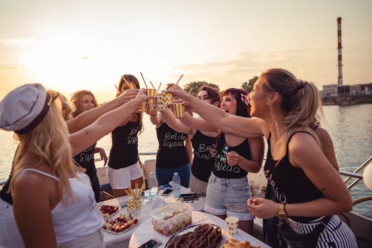 Cheerful bride and bridesmaids celebrating with a bachelorette party, for which they need a bridesma...