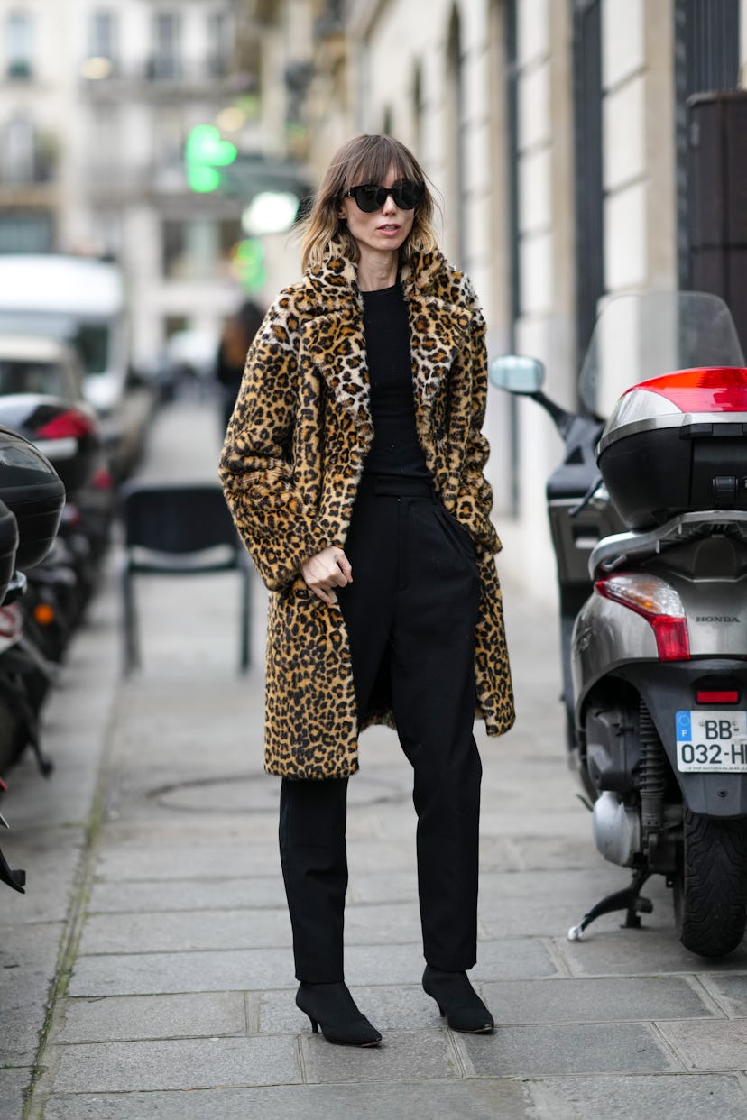 PARIS, FRANCE - JANUARY 26: Anya Ziourova wears black sunglasses, a black t-shirt, high waist black ...