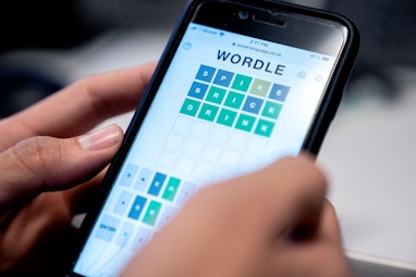 This photo illustration shows a person playing online word game "Wordle" on a mobile phone in Washin...