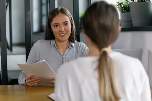 Selective focus shot of two young businesswomen sitting opposite each other, co-working on a project...