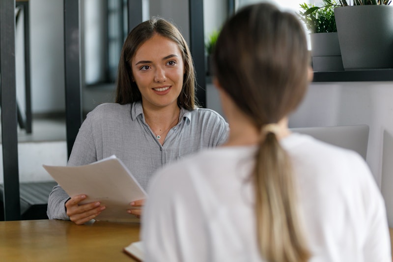 Selective focus shot of two young businesswomen sitting opposite each other, co-working on a project...