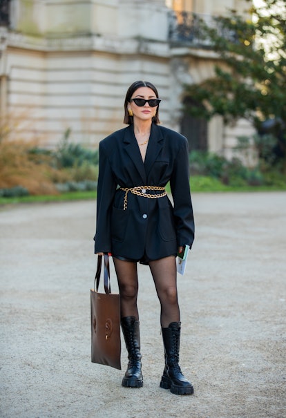 PARIS, FRANCE - JANUARY 24: Alexandra Pereira is seen wearing black blazer, tights, brown bag, laced...