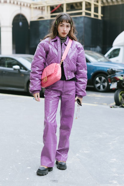 PARIS, FRANCE - JANUARY 27: A guest poses wearing Rotate jacket and pants and a Fendi pink bag after...