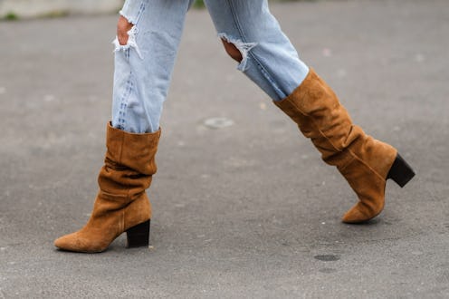 PARIS, FRANCE - JANUARY 27: Sofia Sanchez de Betak wears blue faded denim ripped jeans pants, brown ...
