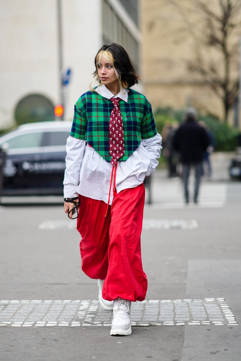 PARIS, FRANCE - JANUARY 27: Gwenaëlle Gillon wears a white oversized shirt, a burgundy with "snoopy"...