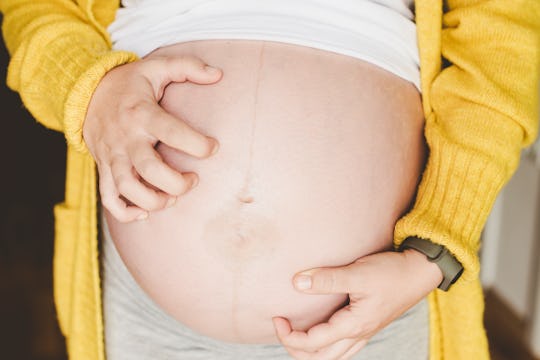 Pregnant woman scratching