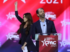 Don Trump, Jr. and Kimberly Guilfoyle stand on stage as they address the Conservative Political Acti...