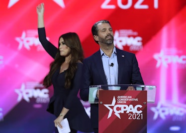 Don Trump, Jr. and Kimberly Guilfoyle stand on stage as they address the Conservative Political Acti...