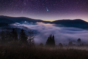 Comet Leonard over misty mountains