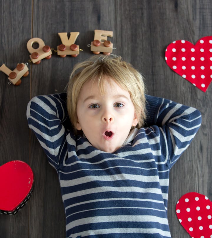 Cute toddler blond child, cute boy with valentine decoration, love, flowers, cake in studio