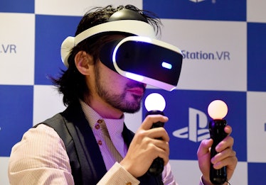 Japanese actor Takayuki Yamada uses PlayStation VR (PSVR) headset during the launch of the product a...