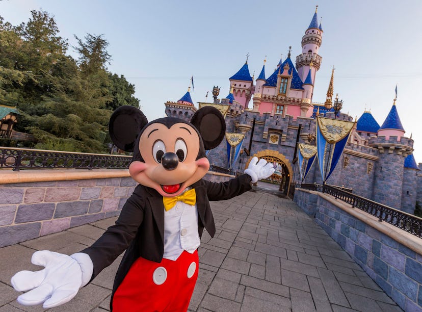 ANAHEIM, CA - AUGUST 27: Mickey Mouse poses in front of Sleeping Beauty Castle at Disneyland Park on...