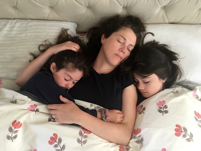 Directly from above view of Mother (female age 30-40) and daughters (females age 7 and 11) sleeping...