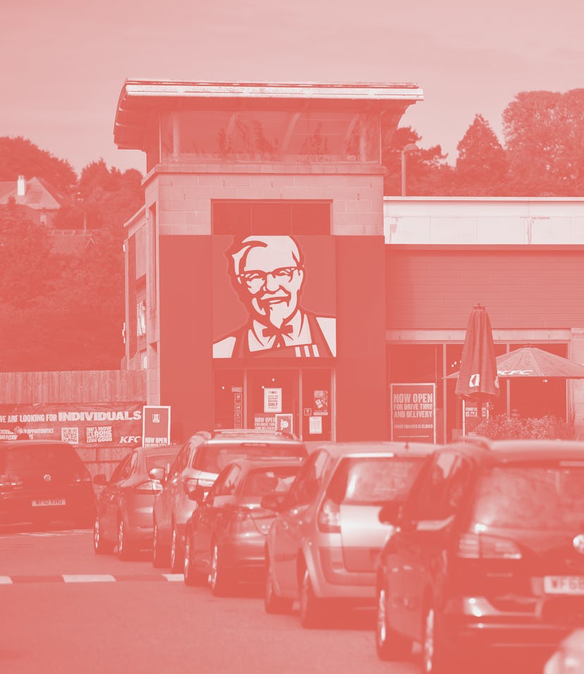 PLYMOUTH, ENGLAND - MAY 08: A long queue of cars forms as the KFC drive through re-opens to the publ...