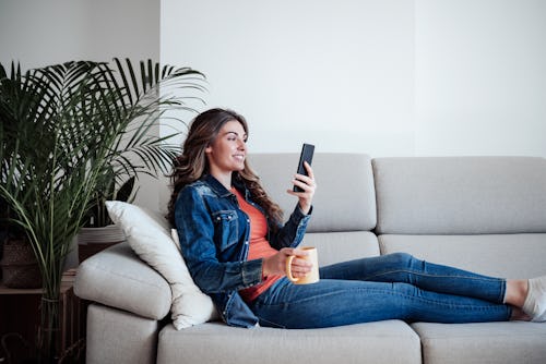A woman scrolls on Instagram using the new chronological "Following" view. How to change your instag...
