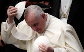 Pope Francis changes his skullcap after the general audience in the Paul VI Hall at the Vatican on D...
