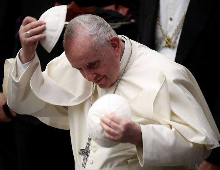 Pope Francis changes his skullcap after the general audience in the Paul VI Hall at the Vatican on D...