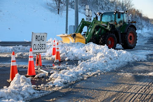 STAFFORD COUNTY, VIRGINIA - JANUARY 04: Road crews used tractors to move snow away from the entrance...