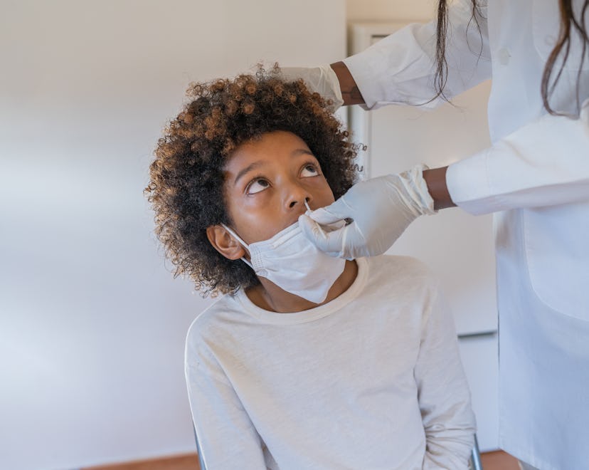 African-American boy undergoing a coronavirus test via her nose