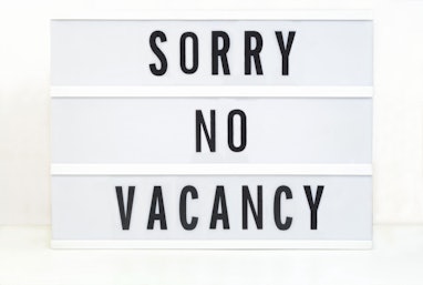 No Job Vacancy sign on light box.