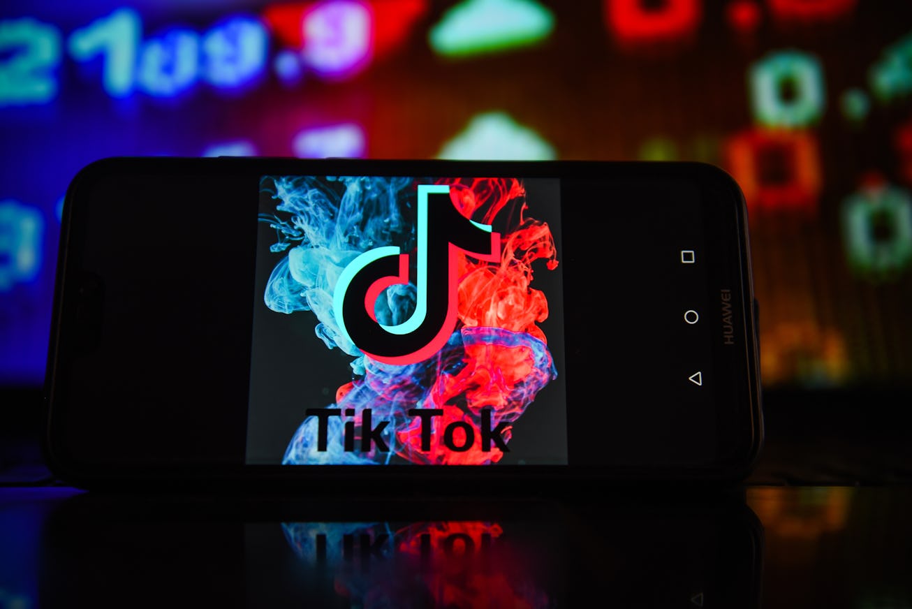 POLAND - 2022/01/03: In this photo illustration a TikTok logo seen displayed on a smartphone with st...